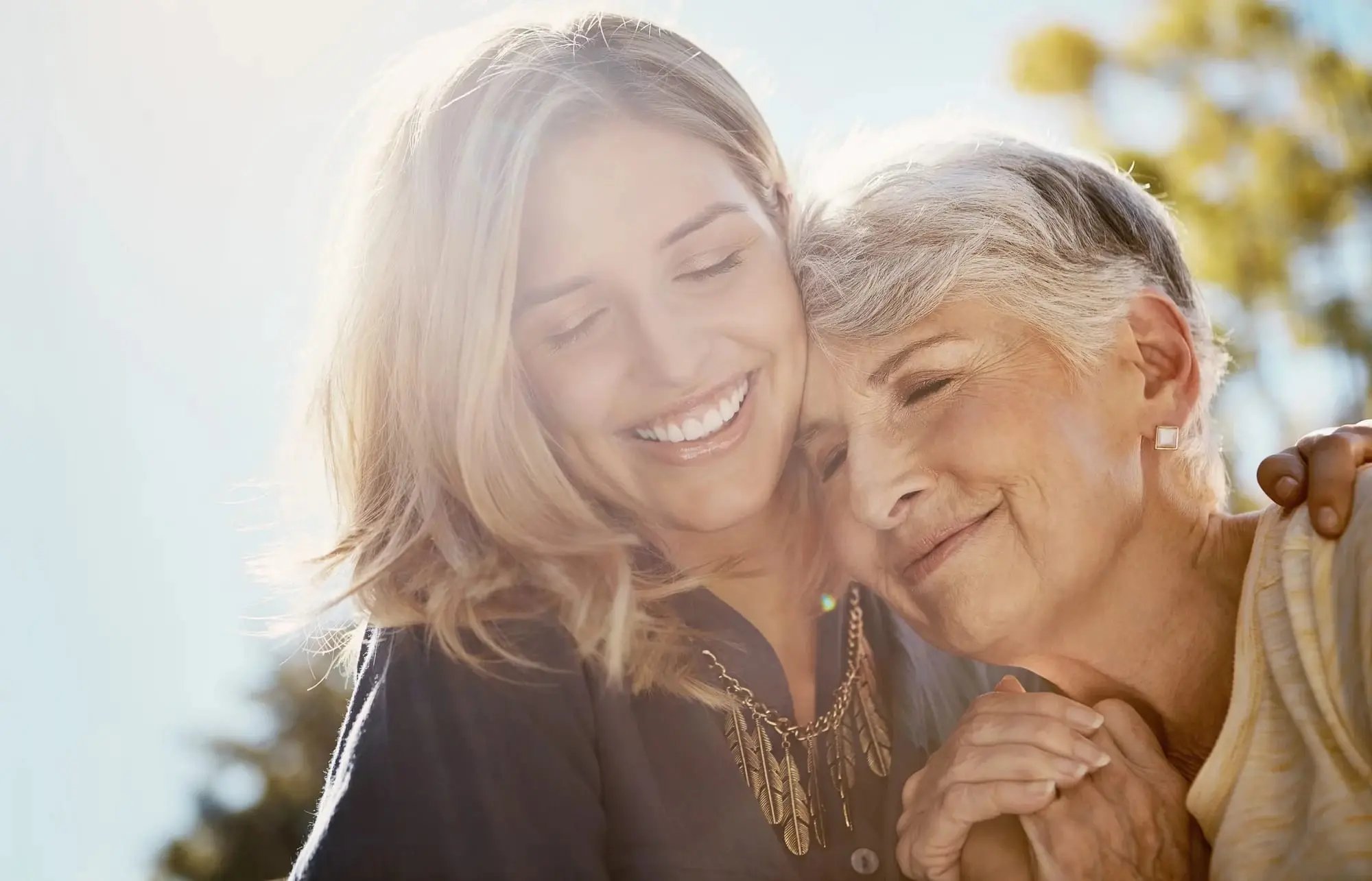 Woman embracing senior mother