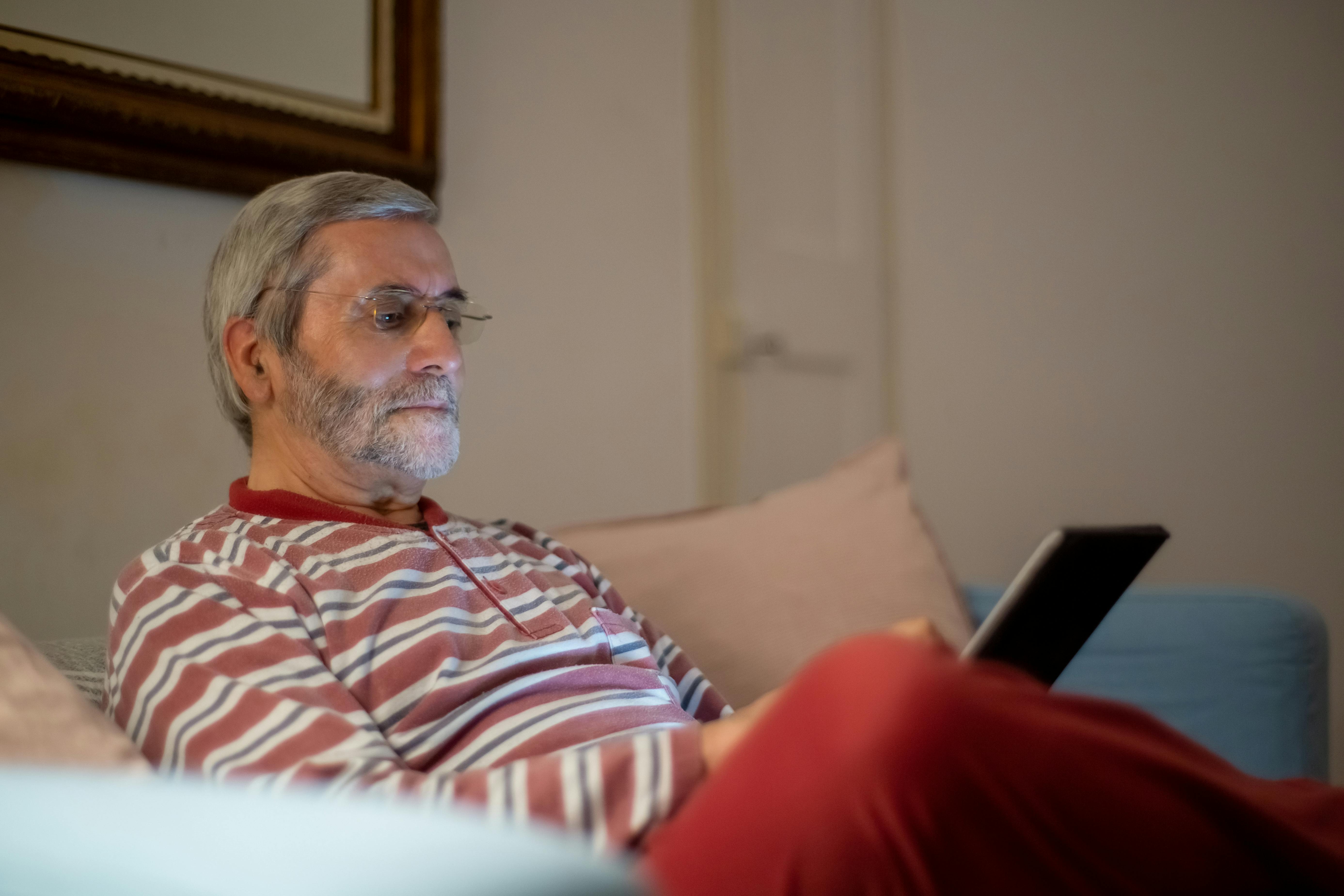 Senior using a tablet to stay connected with family - senior lifestyle management