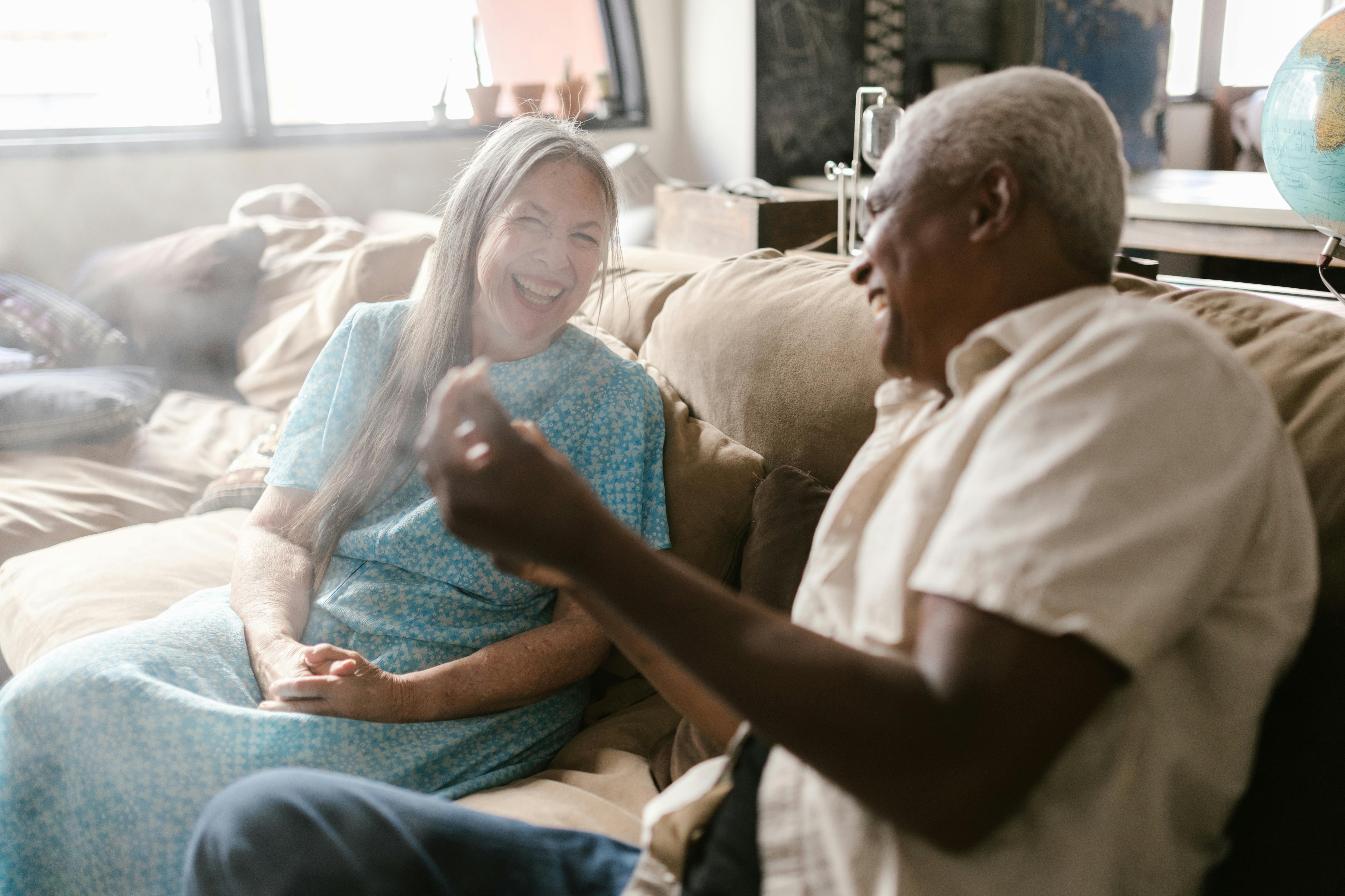 Companion and senior looking at a photo album together - Choosing home care Companion and senior looking at a photo album together - Choosing home care