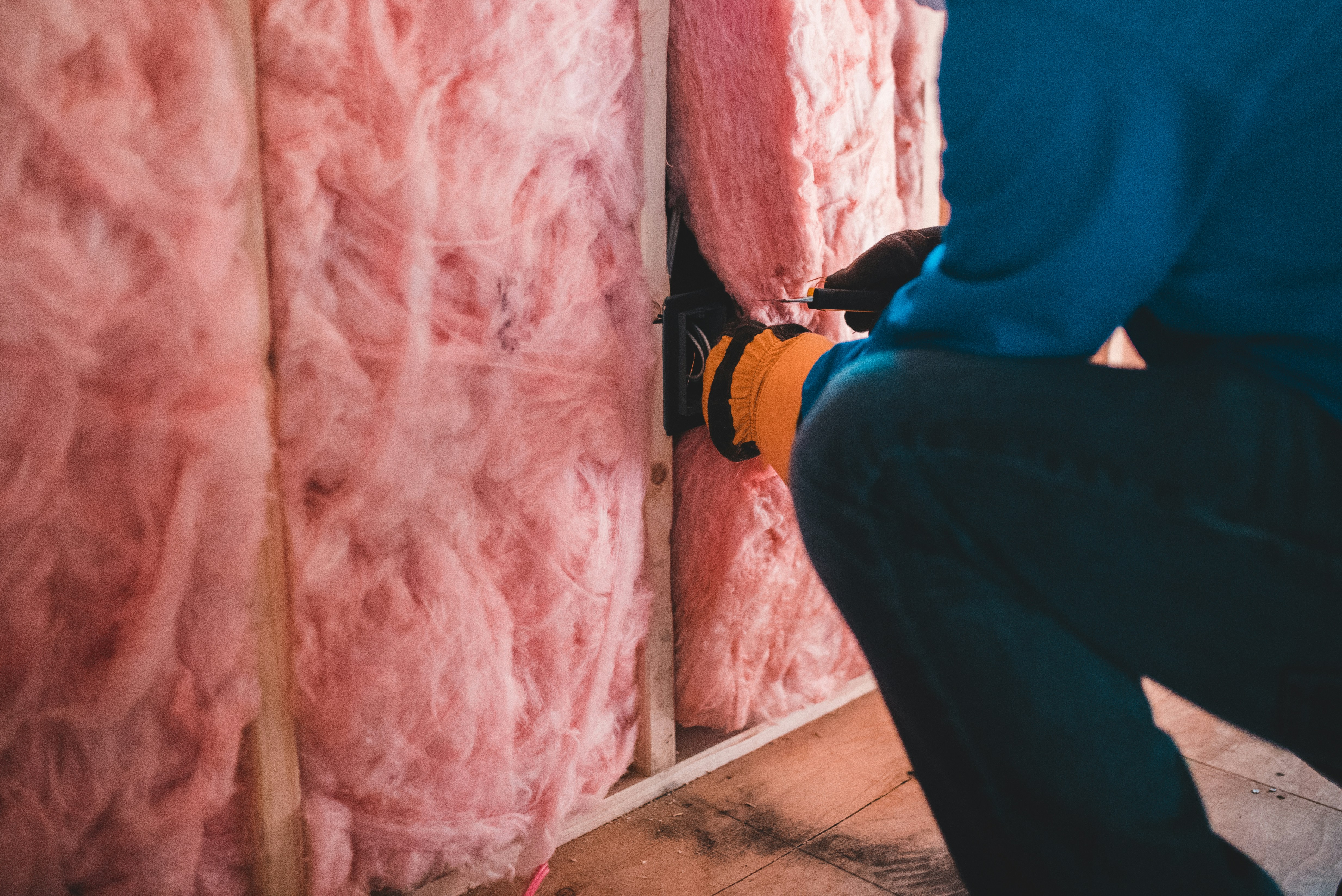 technician installing home insulation - low income grants