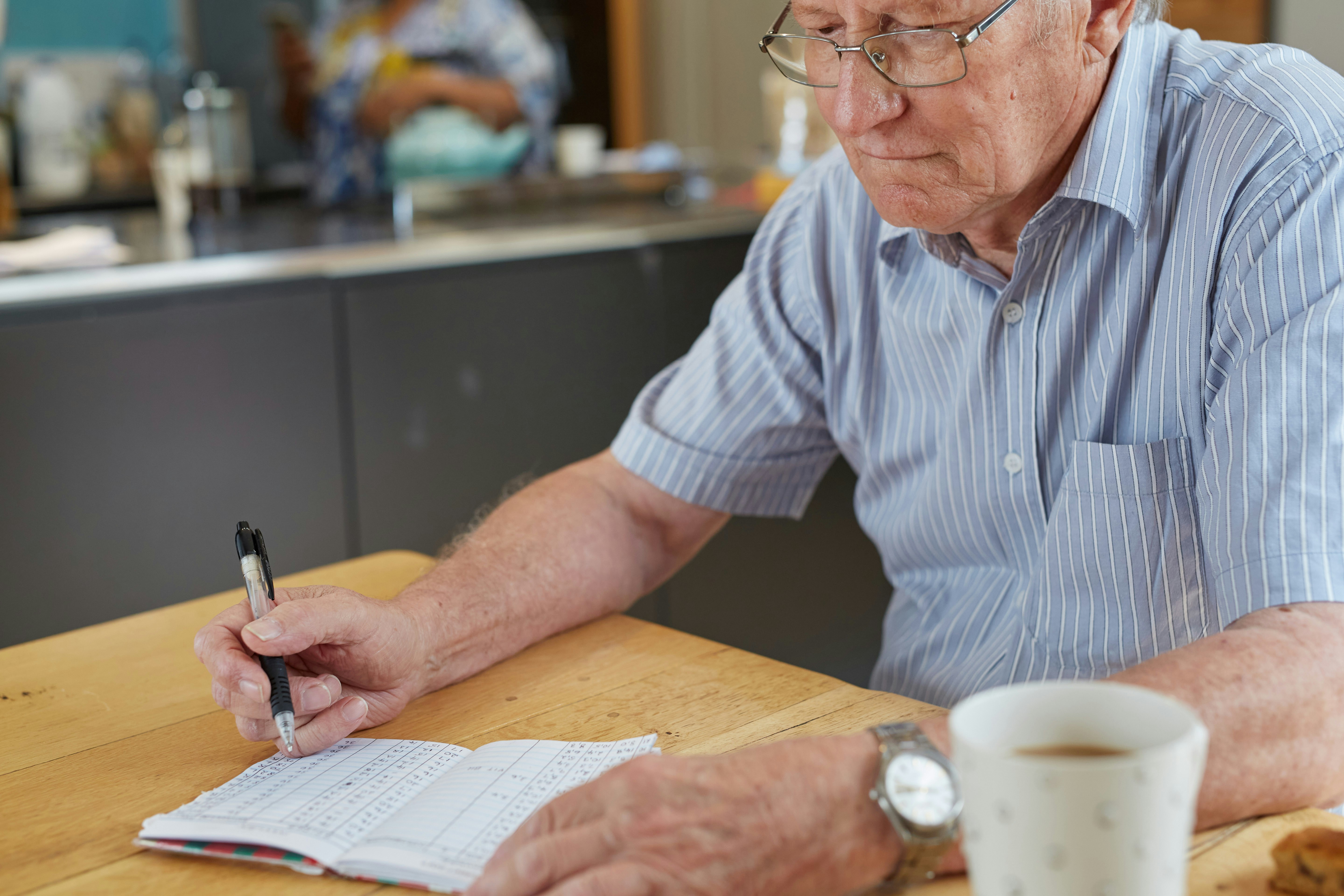 Family caregiver taking notes during a medical appointment - medication management services
