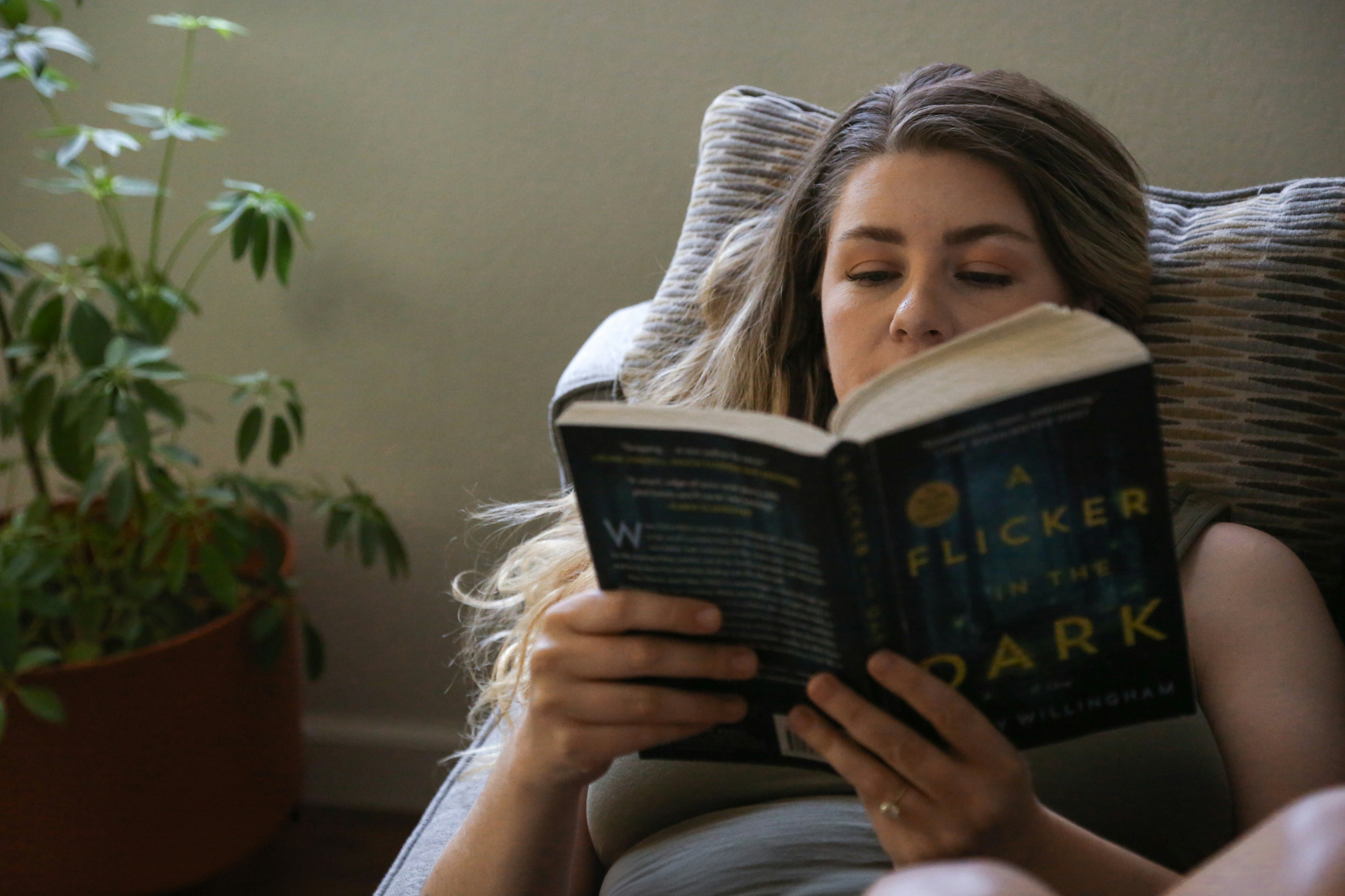 senior comfortably reading in their living room - helping elderly in the community