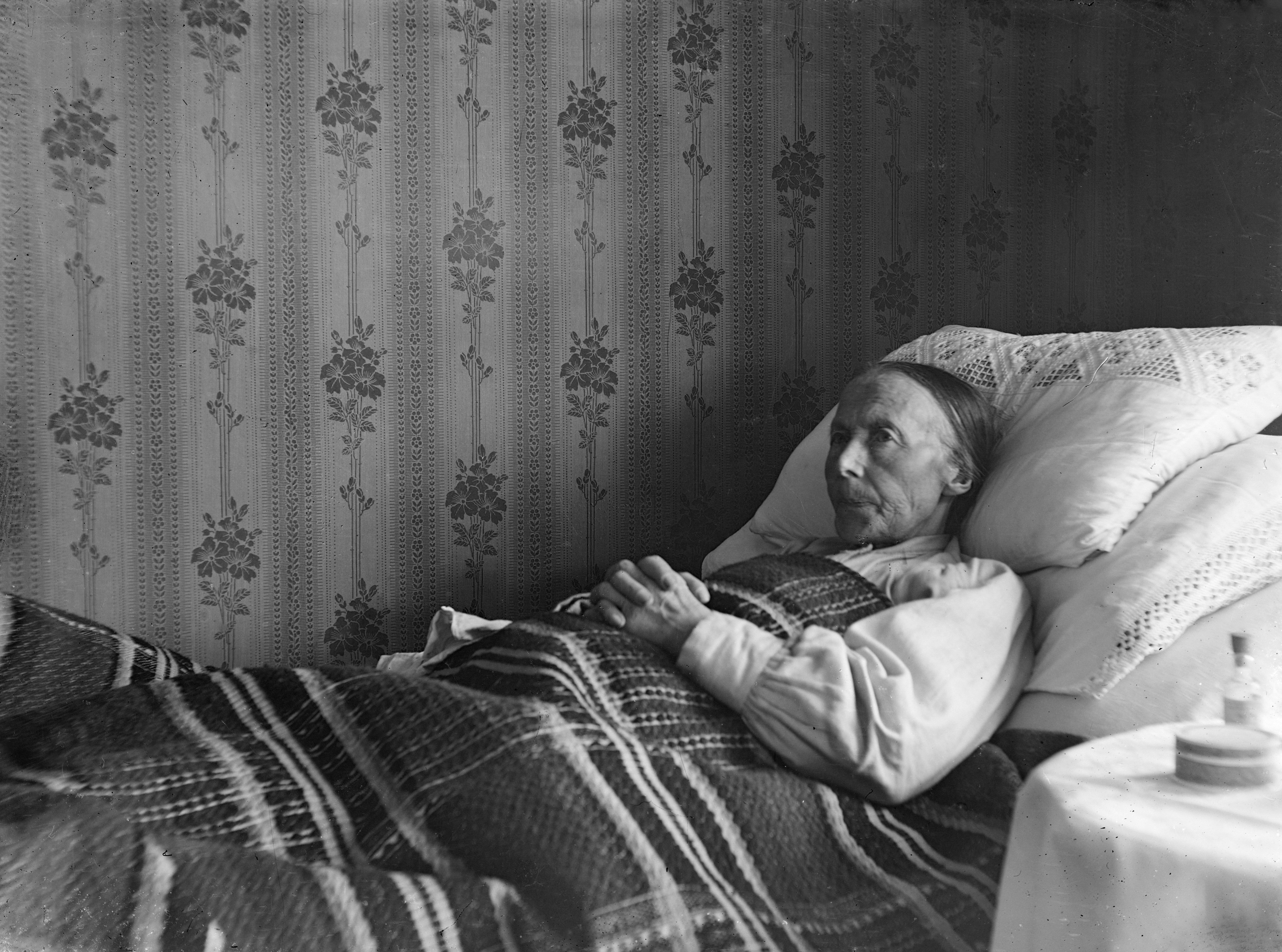 Elderly person using a sturdy bedside rail for support - helping aid for elderly