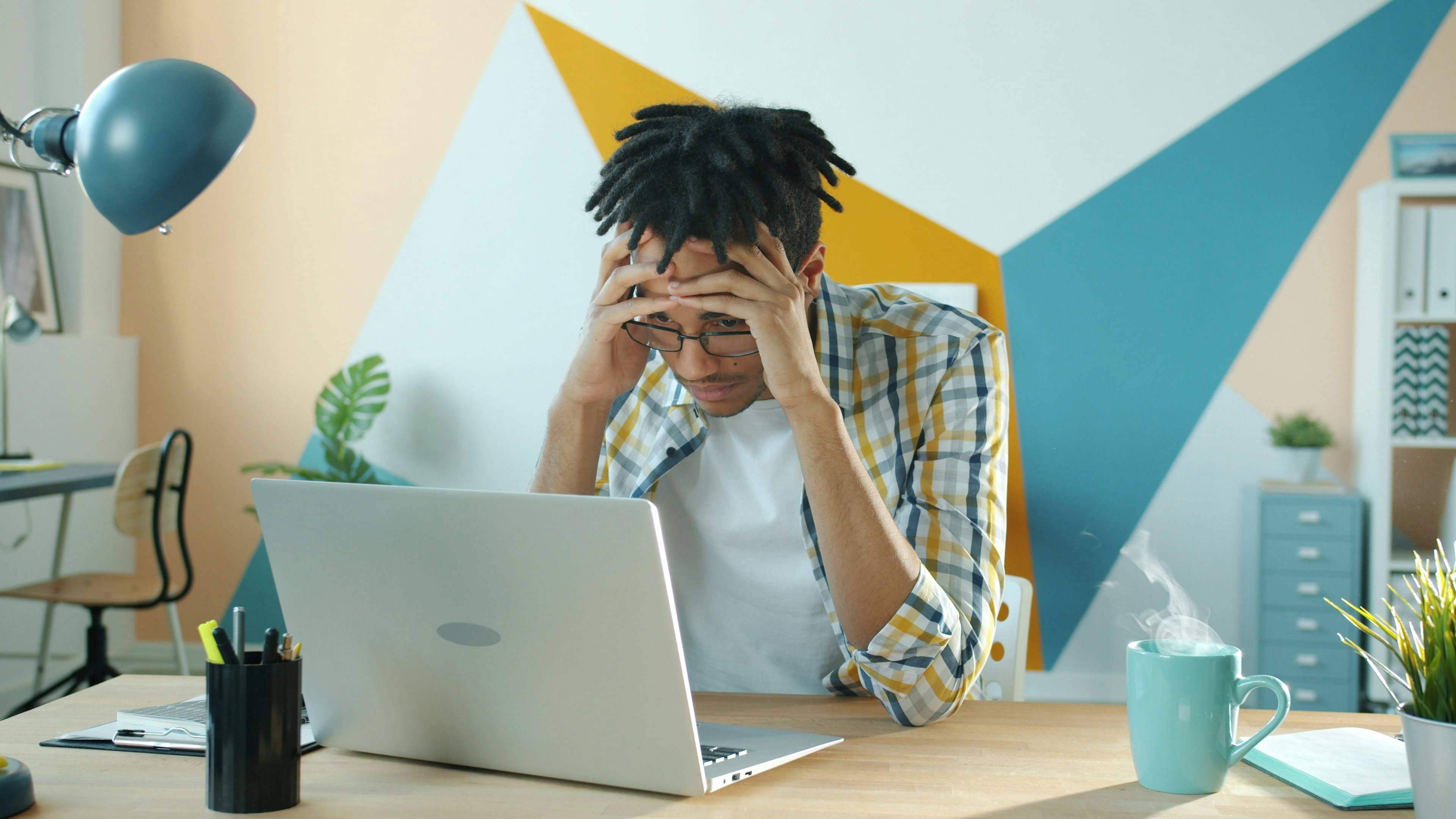 person feeling overwhelmed at a desk - Caregiver self care