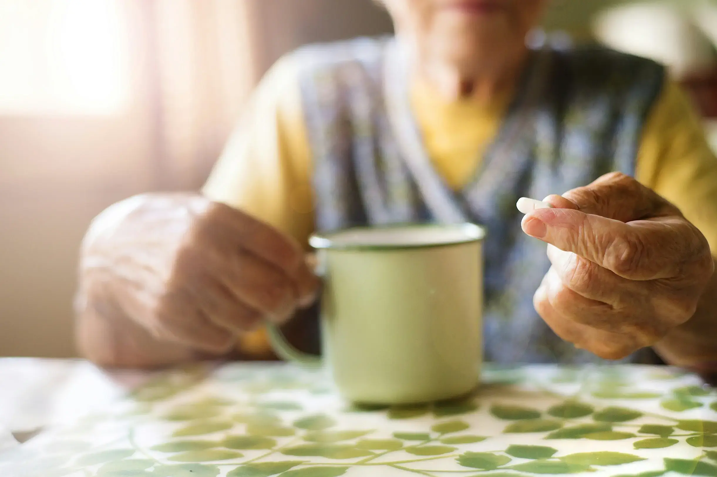 Elder's hands holding a cup